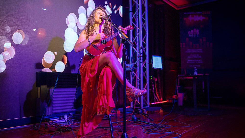 Jessica Mazzoccoli canta e suona dal vivo sul palco durante un concerto